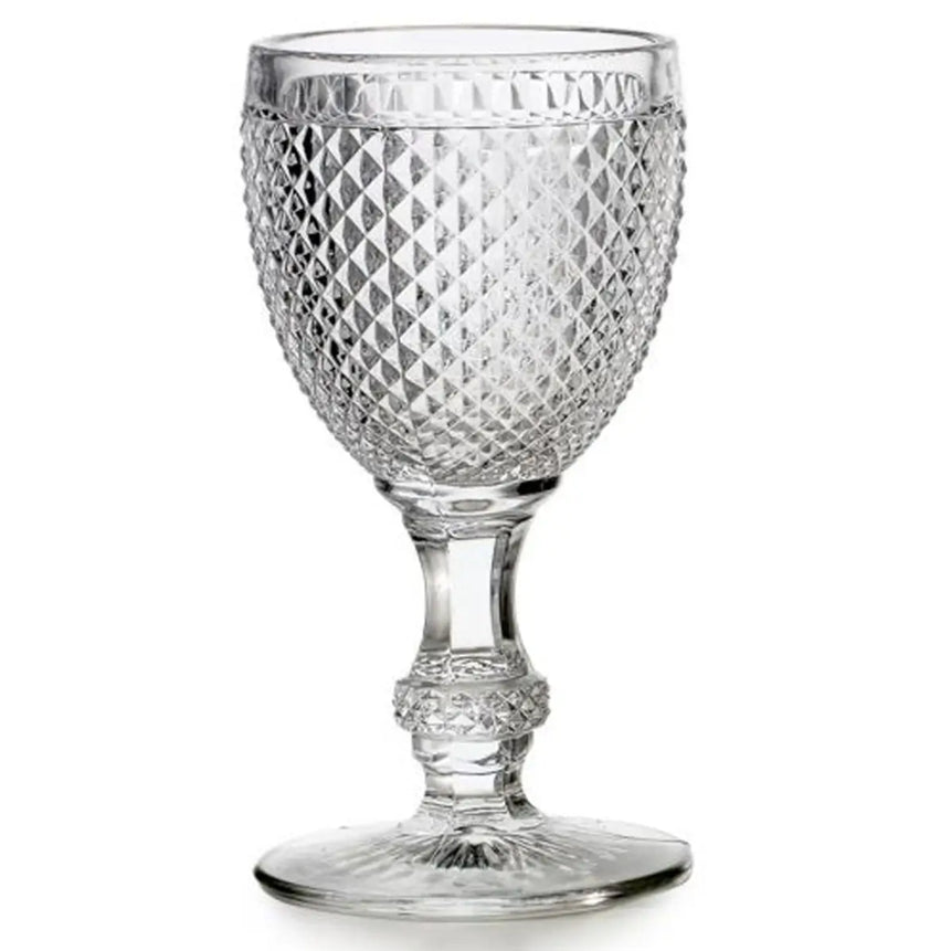 Clear glass goblet with diamond pattern on a white background