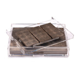 Set of metal tiles in a clear acrylic box on a white background
