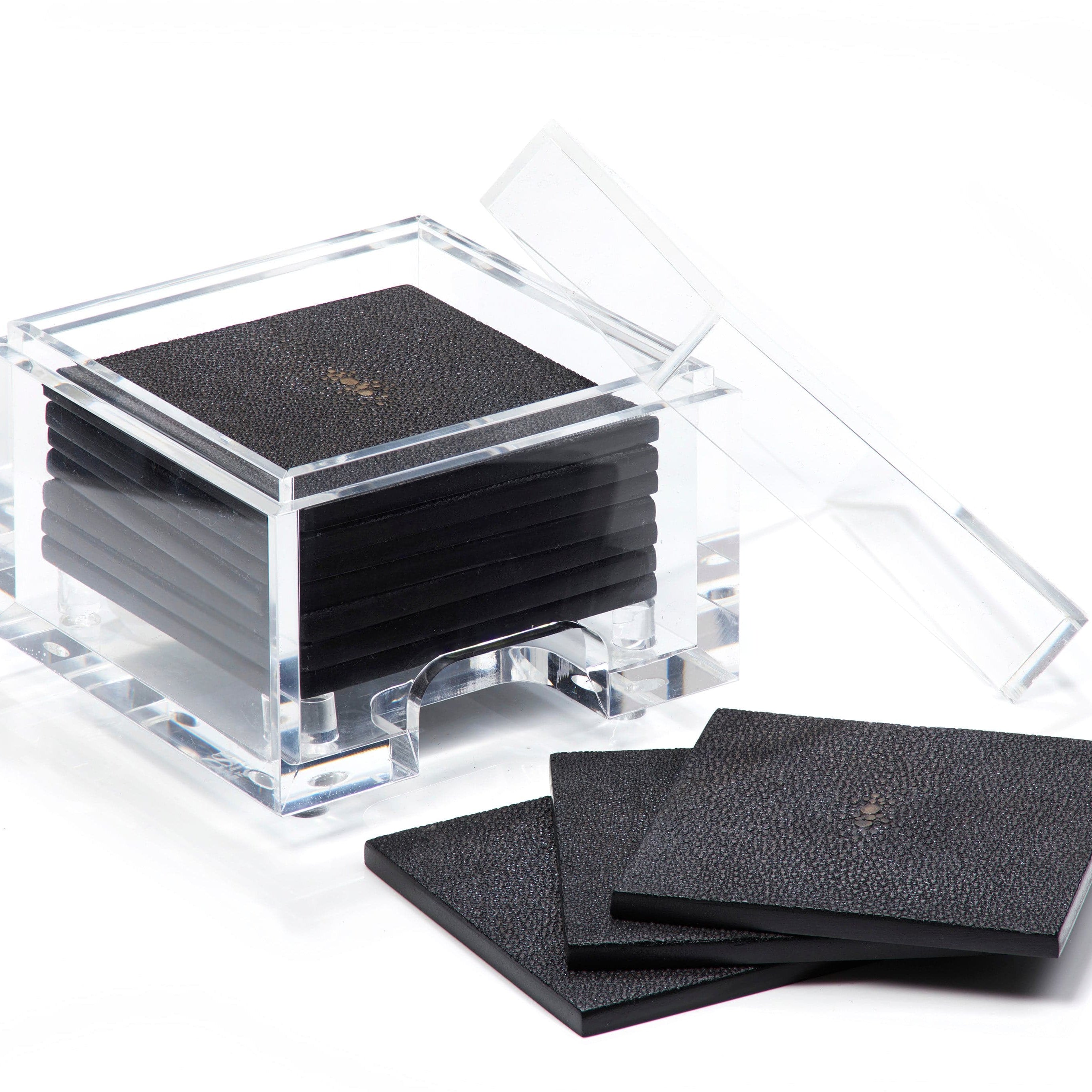 Set of black coasters with a clear acrylic holder on a white background
