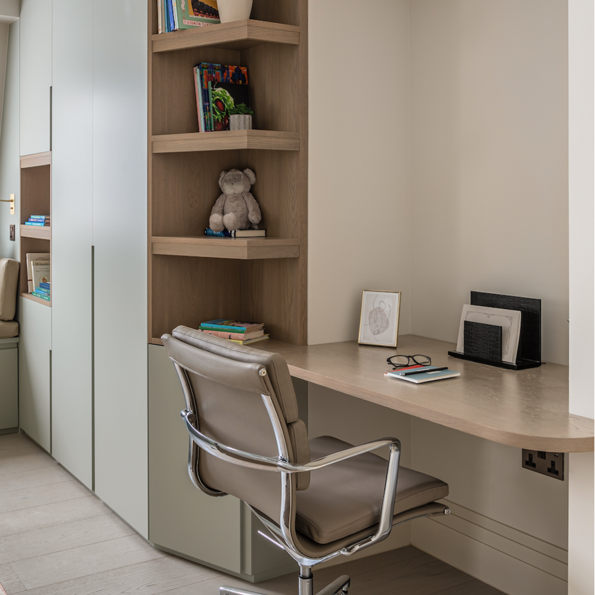 Modern home office with a desk, chair, and shelves.