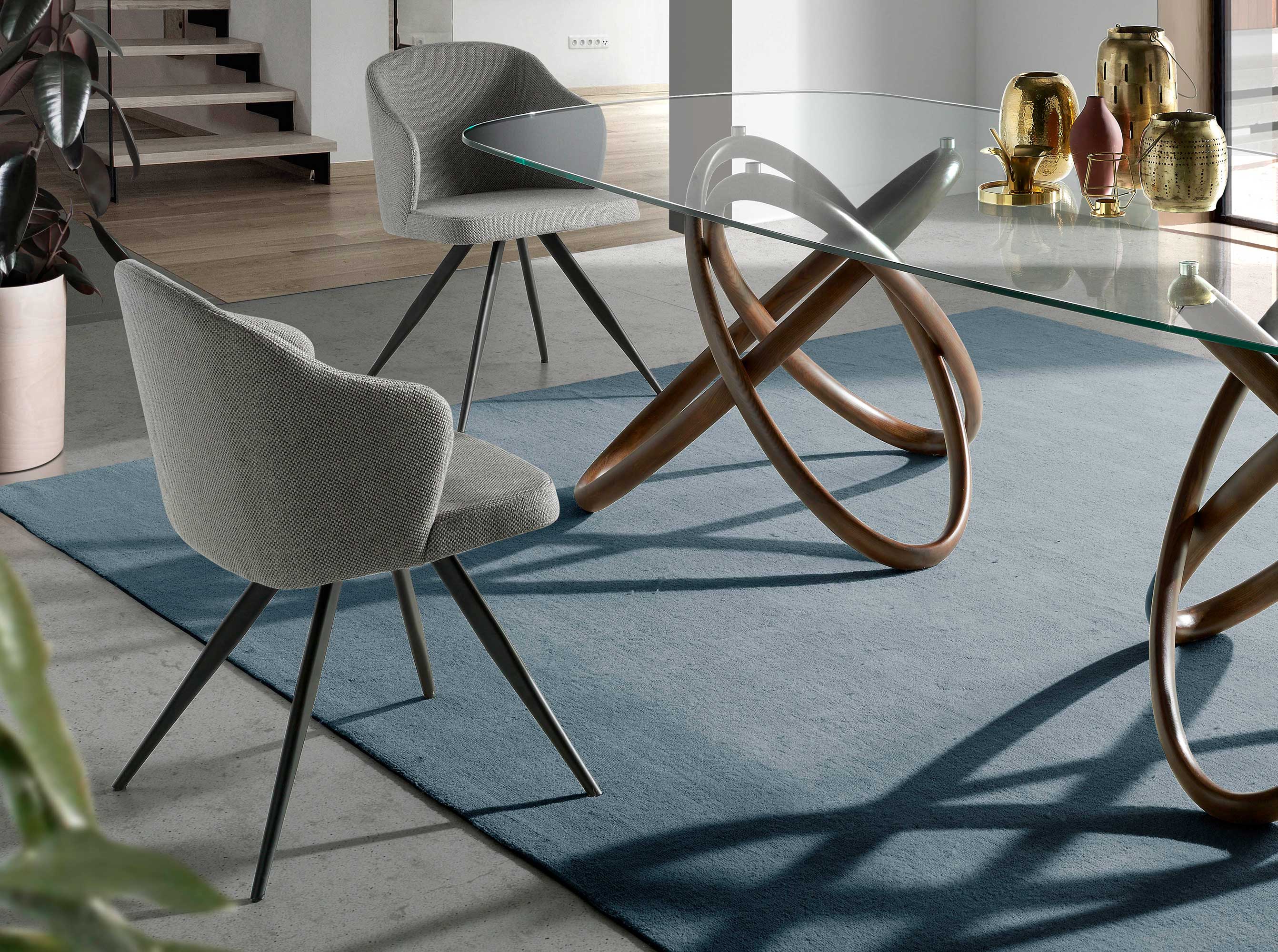 Chair upholstered in fabric with black steel legs